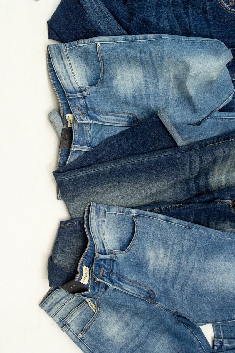 A pile of jeans laying on top of each other